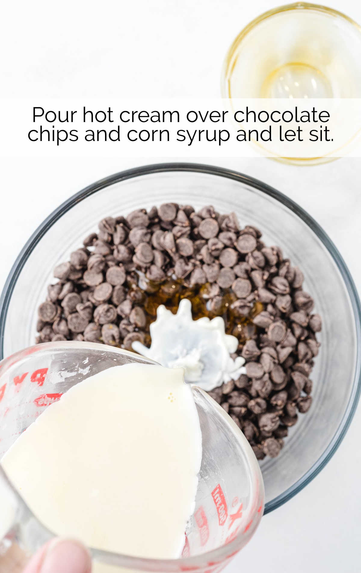 hot cream poured over a bowl of chocolate chips and corn syrup