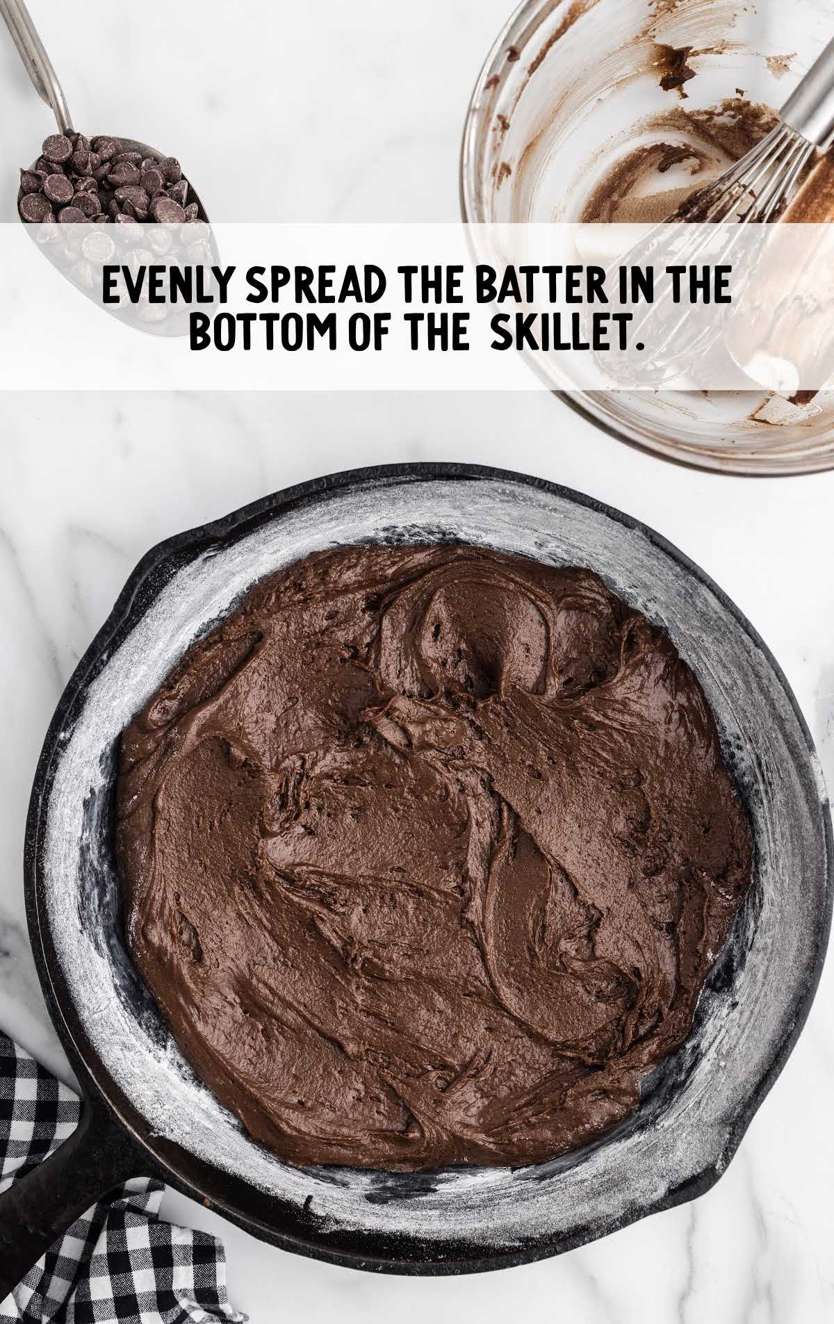 cake batter spread into the bottom of a skillet