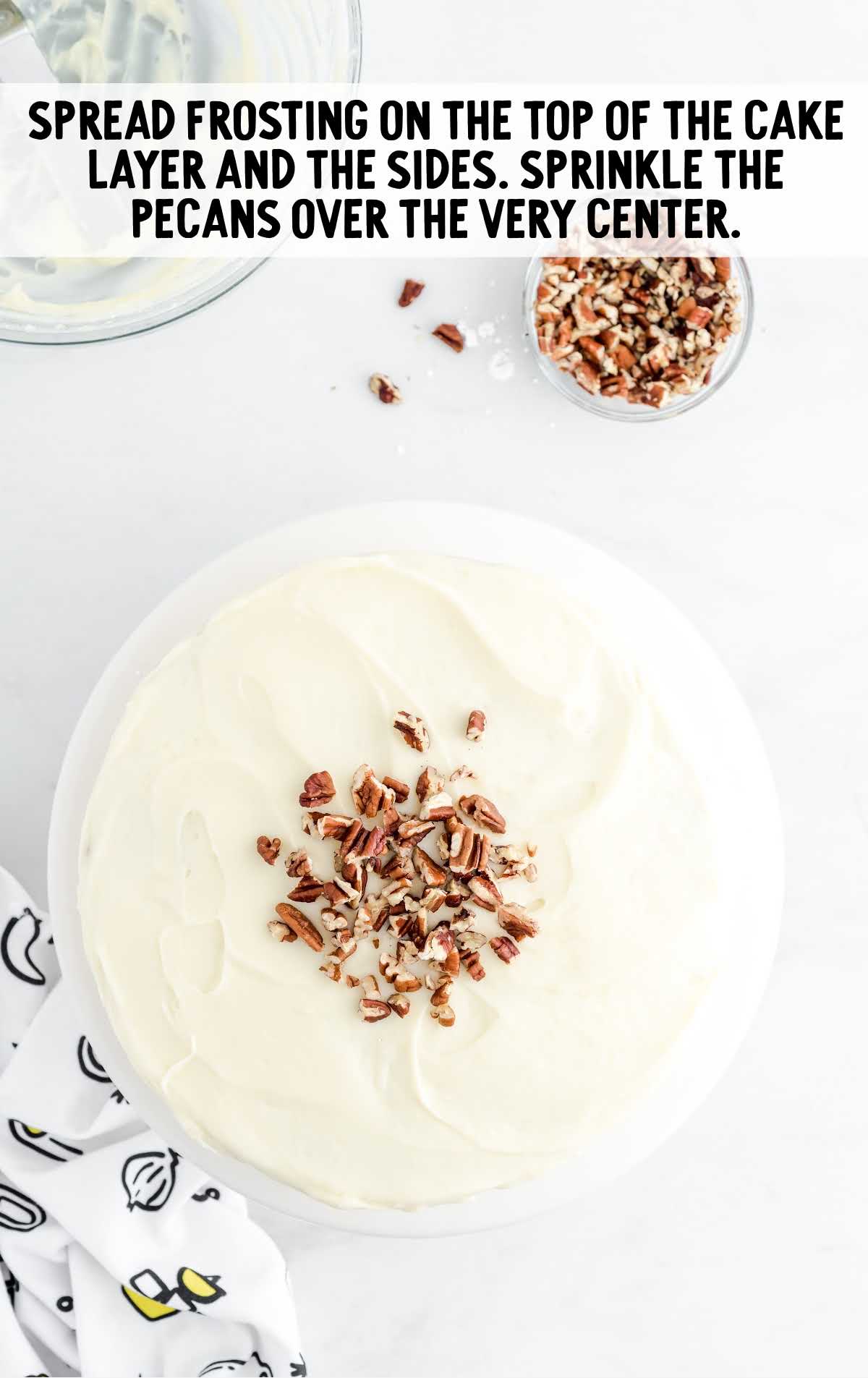 cake frosted and sprinkled with pecans