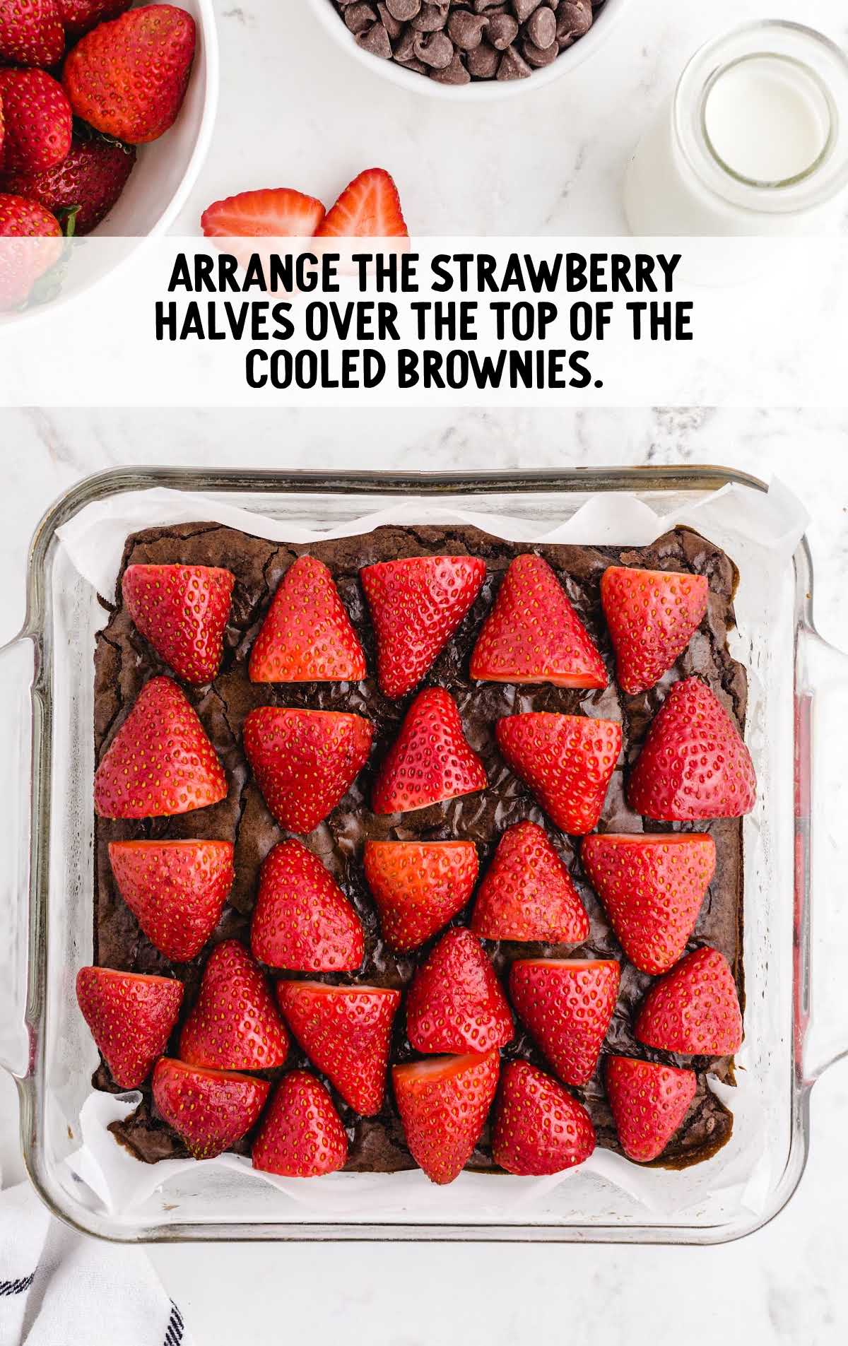 strawberry halves arranged on top of the cooled brownies