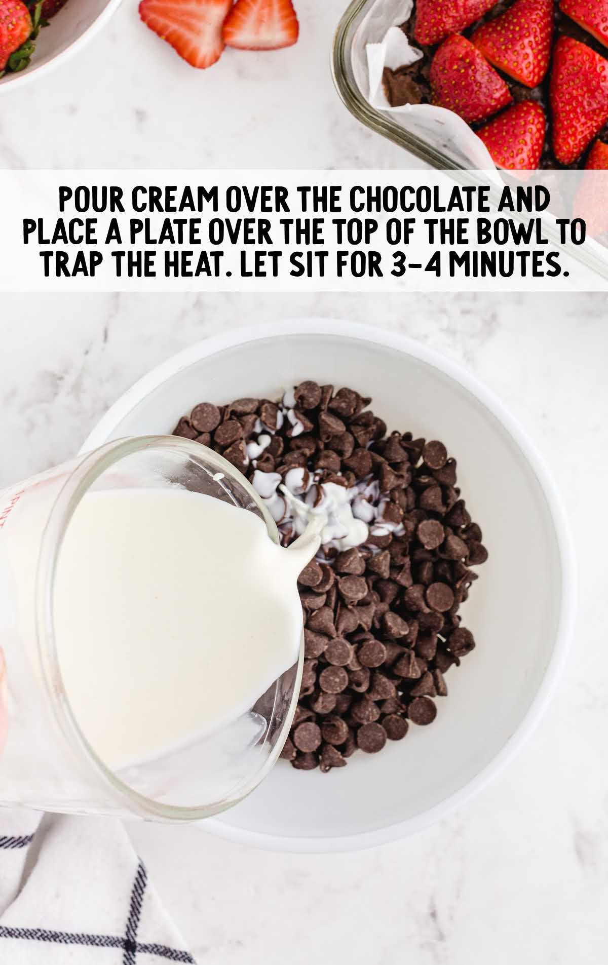 heavy cream being poured over chocolate chips