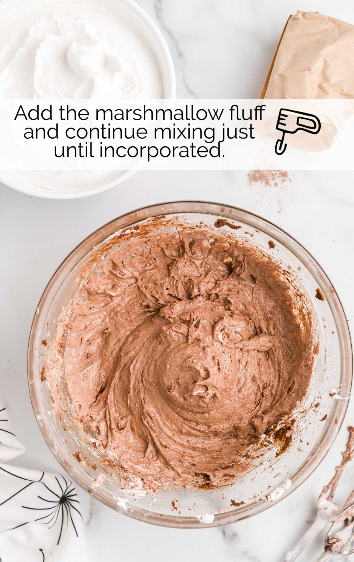 marshmallow fluff added to the cream cheese mixture in a bowl