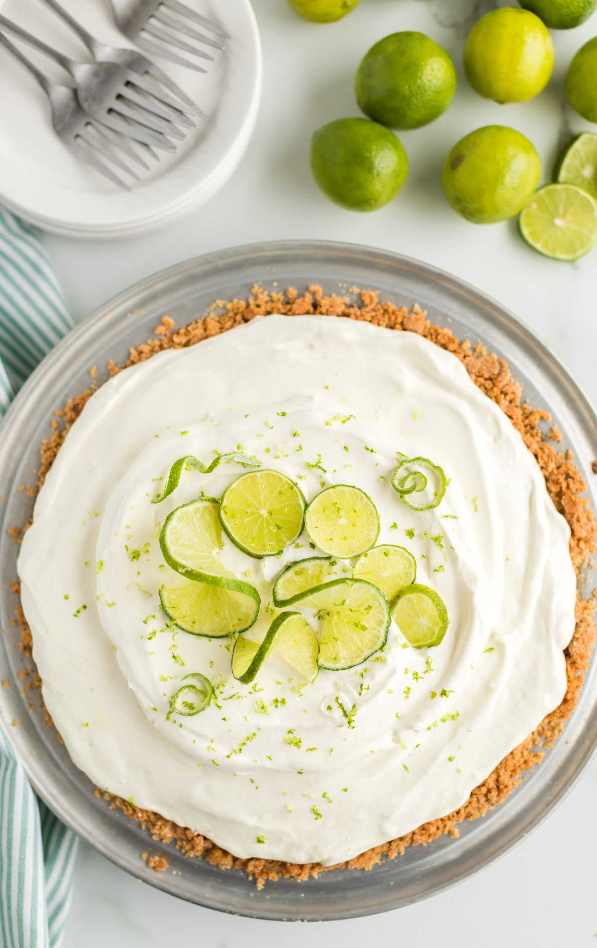 overhead shot of a whole Key Lime Pie garnished with lime on a large tray