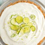 overhead shot of a whole Key Lime Pie garnished with lime on a large tray