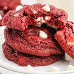 close up shot of a plate of Red Velvet Cookies stacked on top of each other