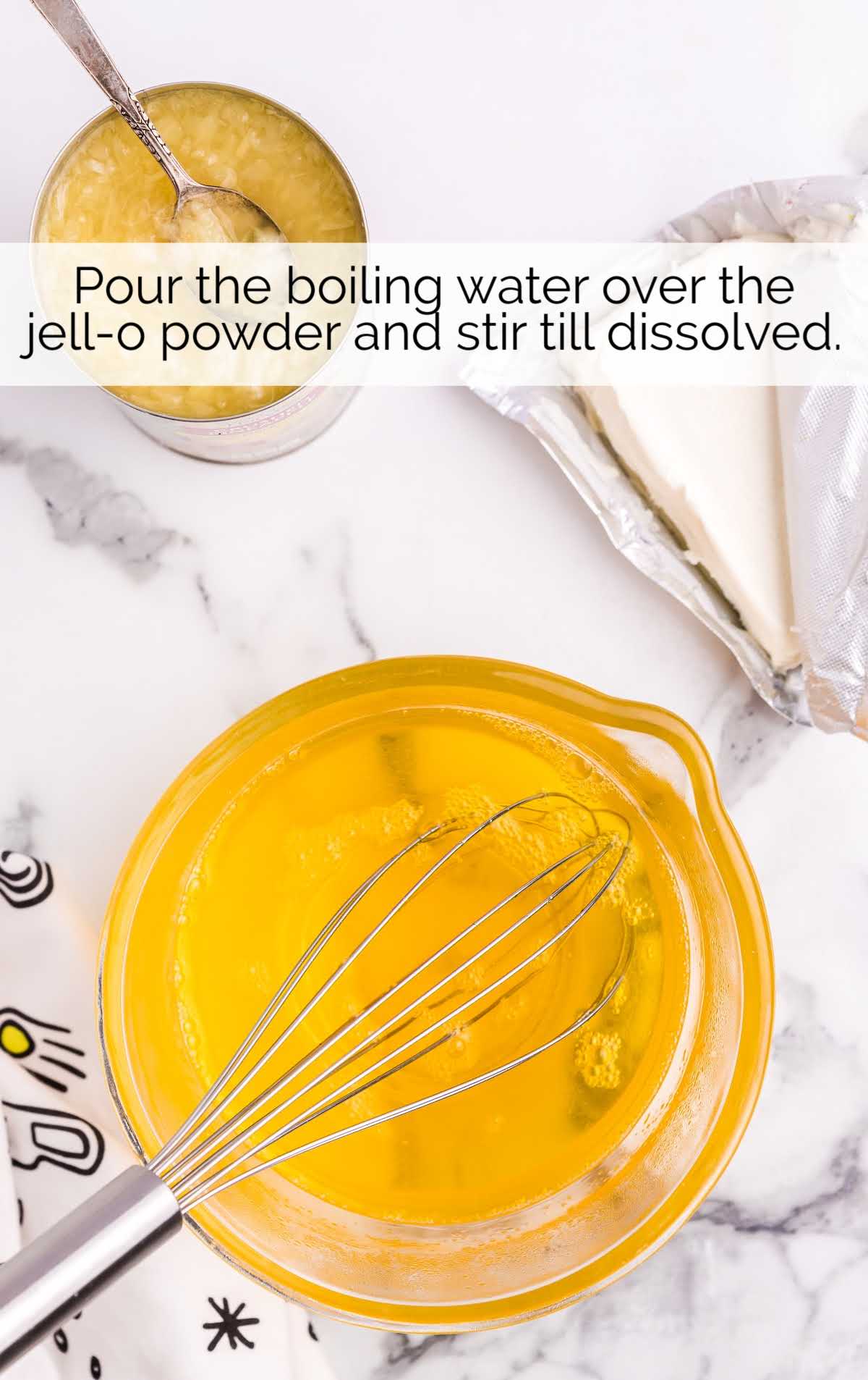boiling water and jell-o powder whisked together in a bowl