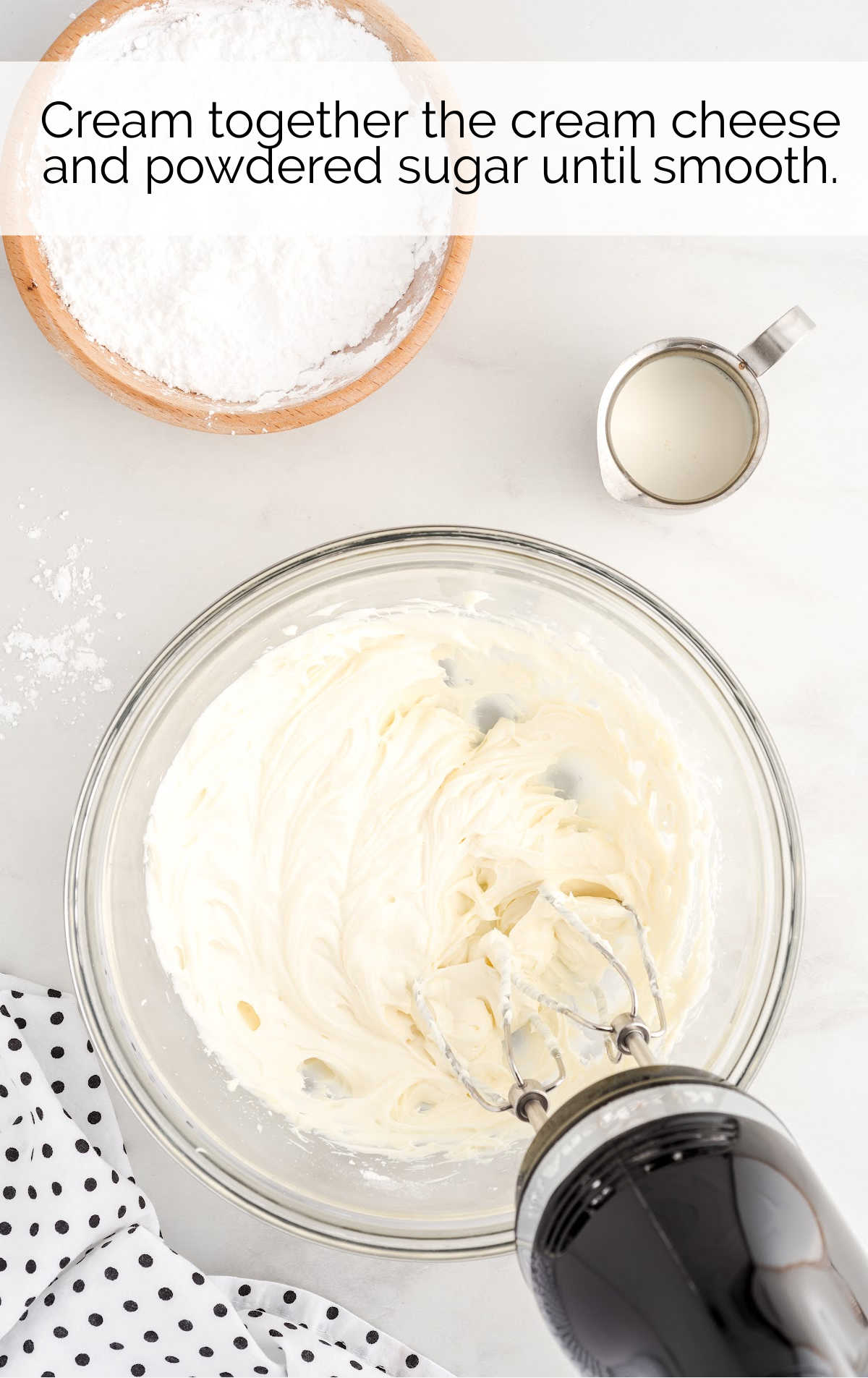 cream cheese and powdered sugar whisked together in a bowl