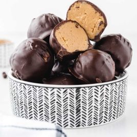 close up shot of Peanut Butter Balls stacked on top of each other in a bowl
