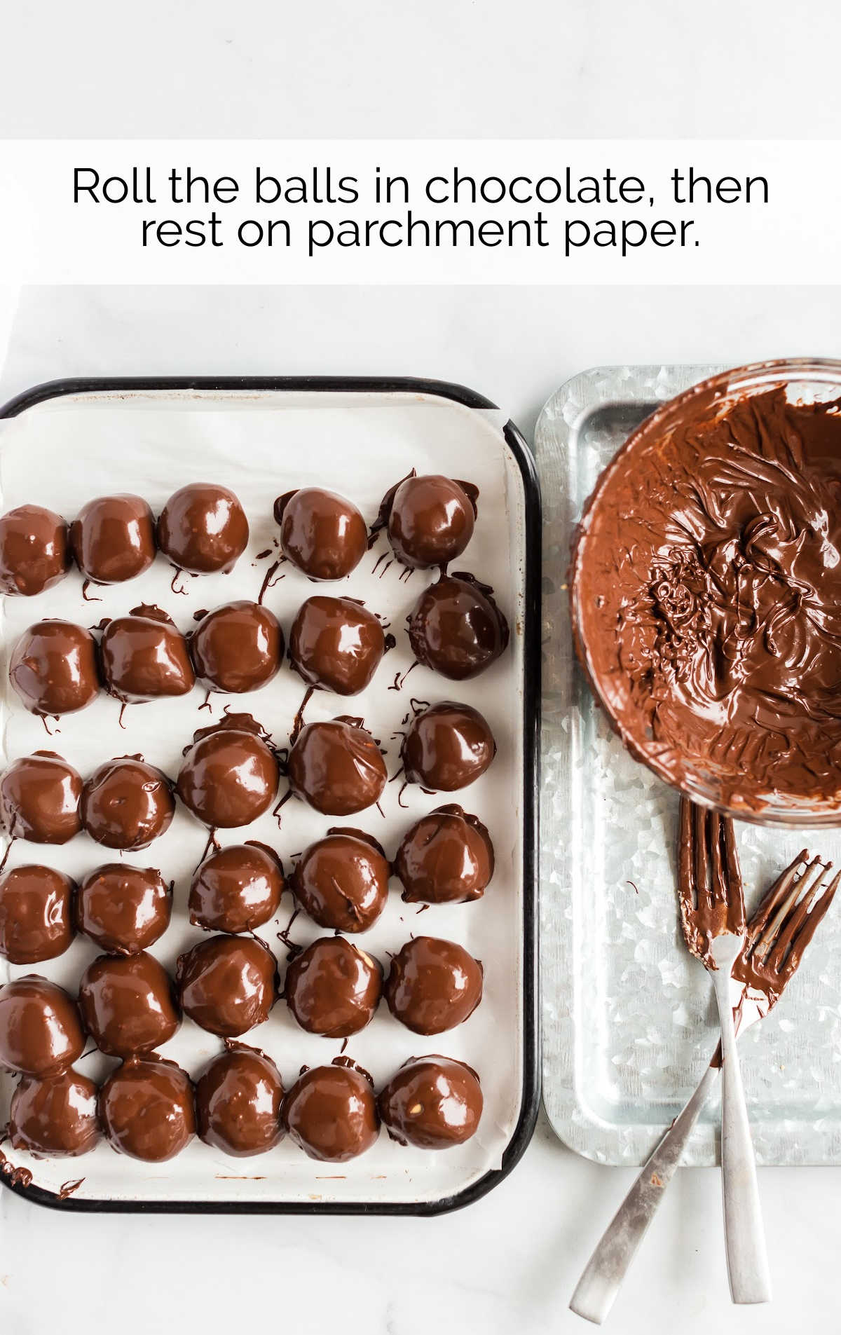 peanut butter balls dipped into a bowl of melted chocolate then placed on parchment paper