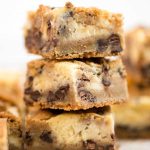 close up shot of Chocolate Chip Cheesecake Bars stacked on top of each other