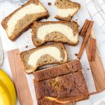 over head shot of Cream Cheese Banana Bread sliced into pieces on a parchment line sheet