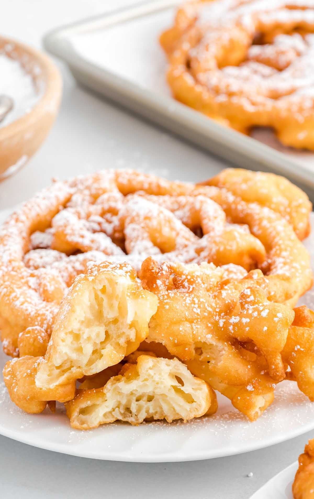 Funnel Cake topped with powdered sugar in a plate 