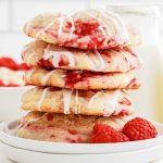 close up shot of Lemon Raspberry Cookies stacked on top of each other on a plate