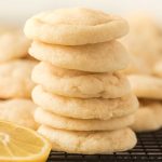 Lemon Sugar Cookies stacked on top of each other on a cooling rack