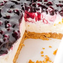 close up shot of No Bake Blueberry Cheesecake with a slice missing