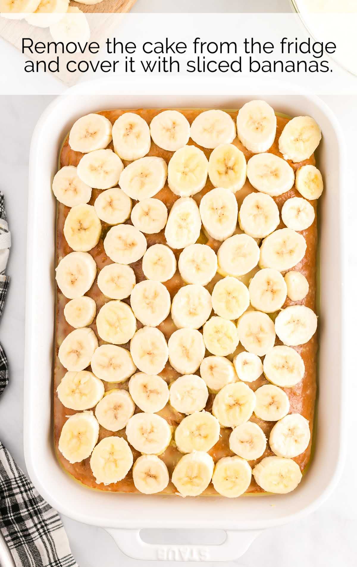 cake covered with banana slices in a baking dish