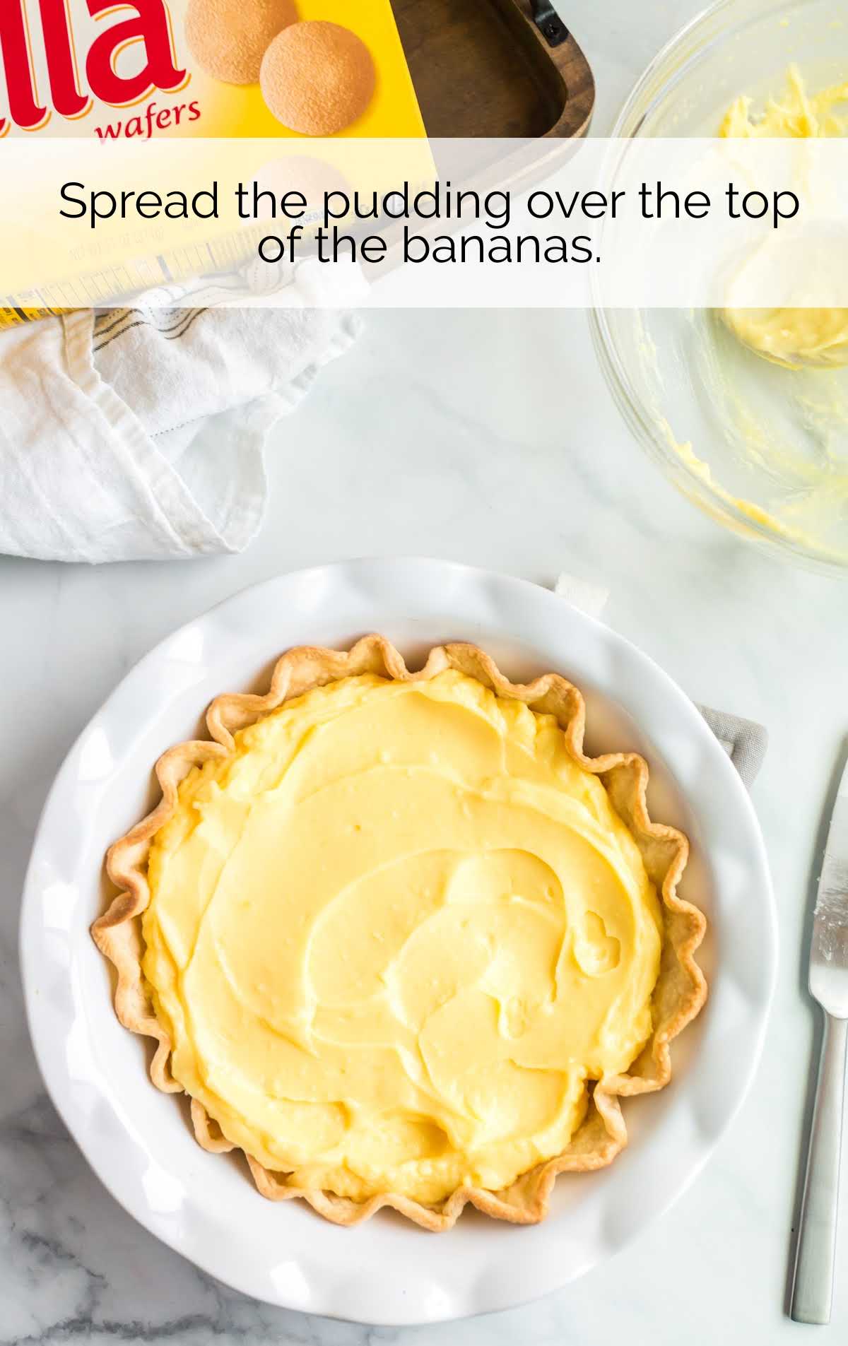 pudding spread over the top of the banana in a pie crust