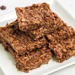 a bunch of No Bake Chocolate Oatmeal Cookie Bars stacked on top of each other on a plate
