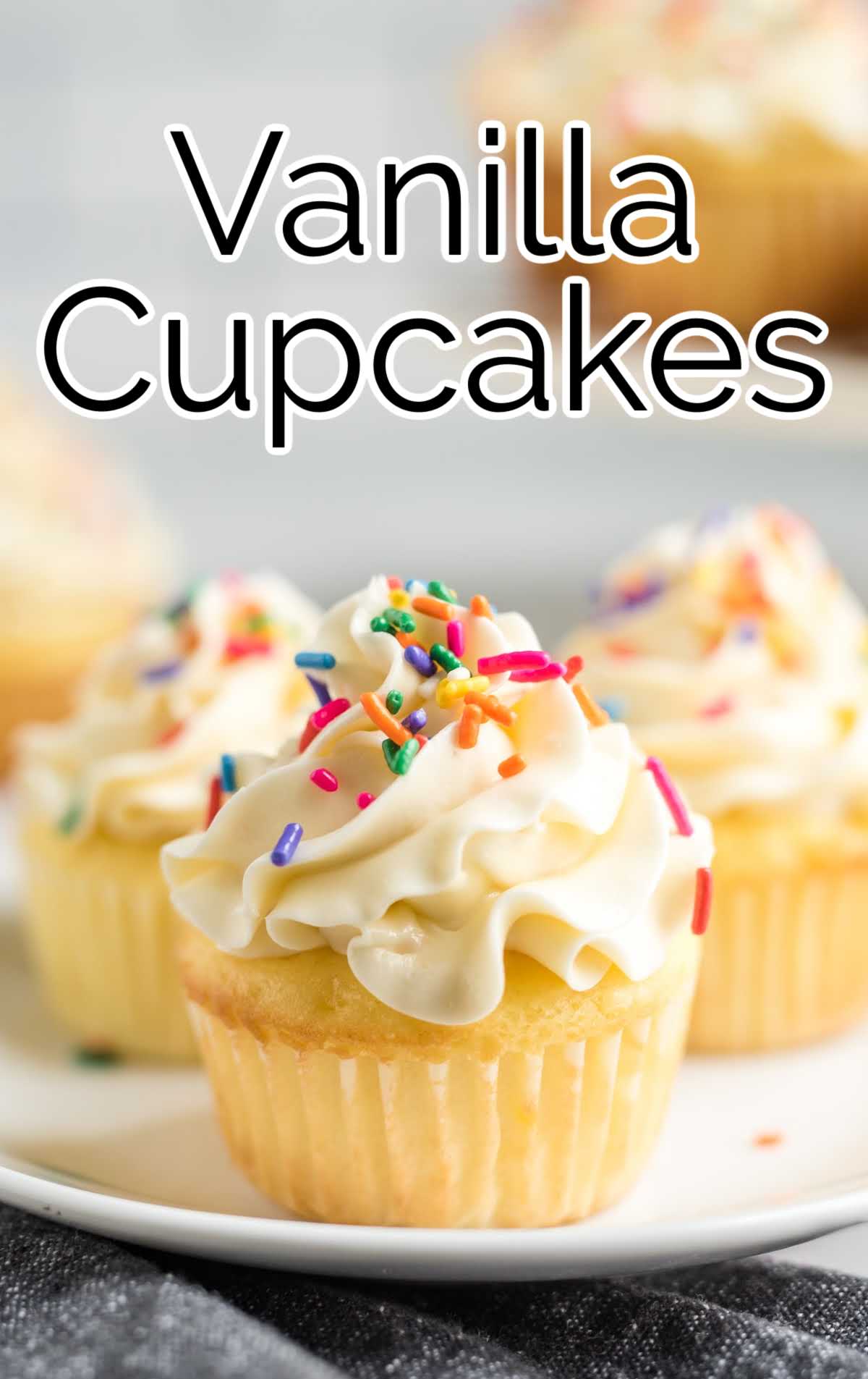 Vanilla Cupcakes topped with sprinkles on a plate