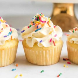 close up shot of Vanilla Cupcakes topped with sprinkles