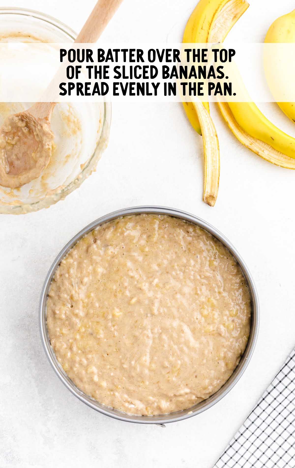 batter poured over the top of the sliced bananas in a pan