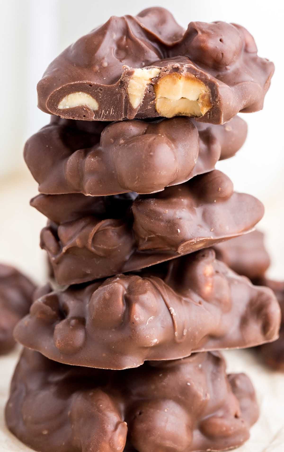close up shot of Chocolate Peanut Clusters stacked on top of each other