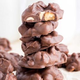 close up shot of Chocolate Peanut Clusters stacked on top of each other