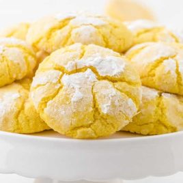 close up shot of Lemon Crinkle Cookies on top of each other in a cake stand