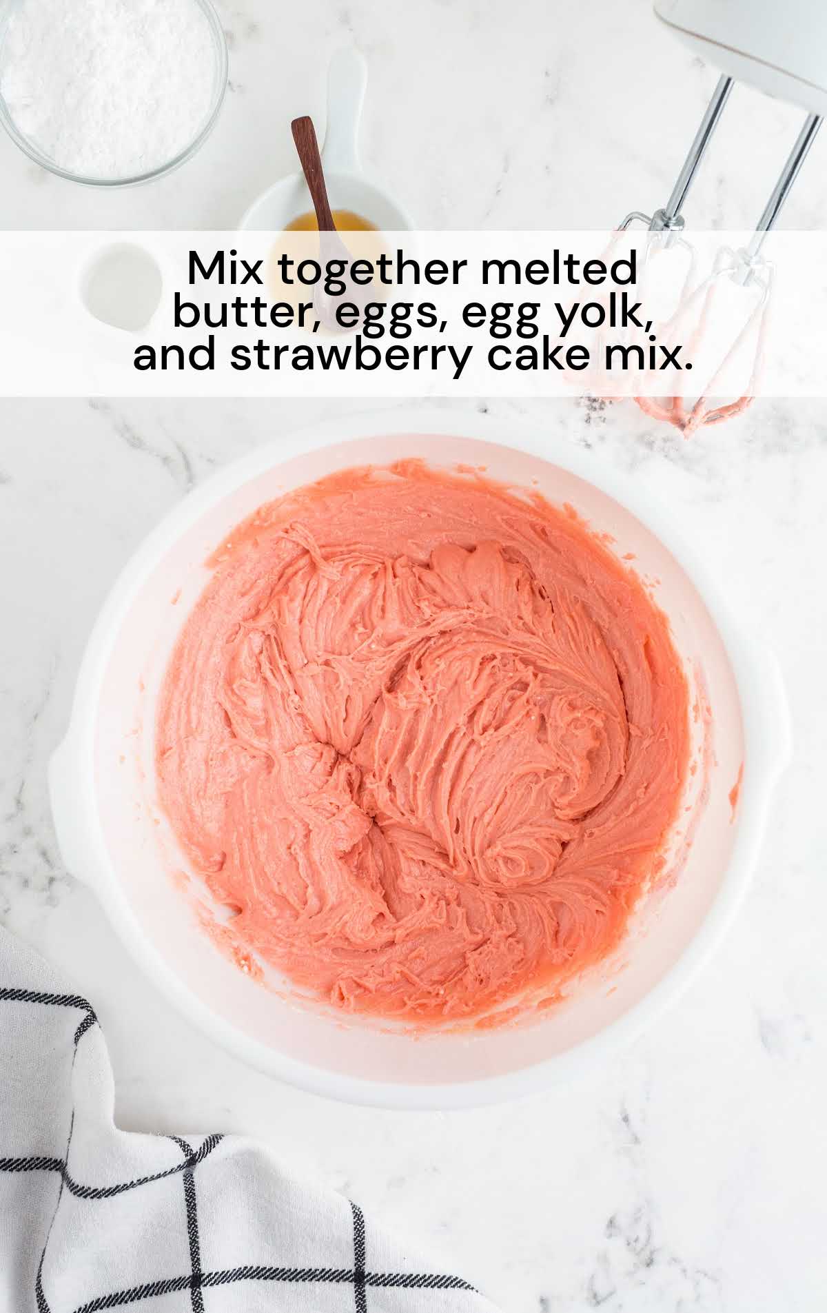 butter, eggs, egg yolk, and strawberry cake mix mixed together in a bowl