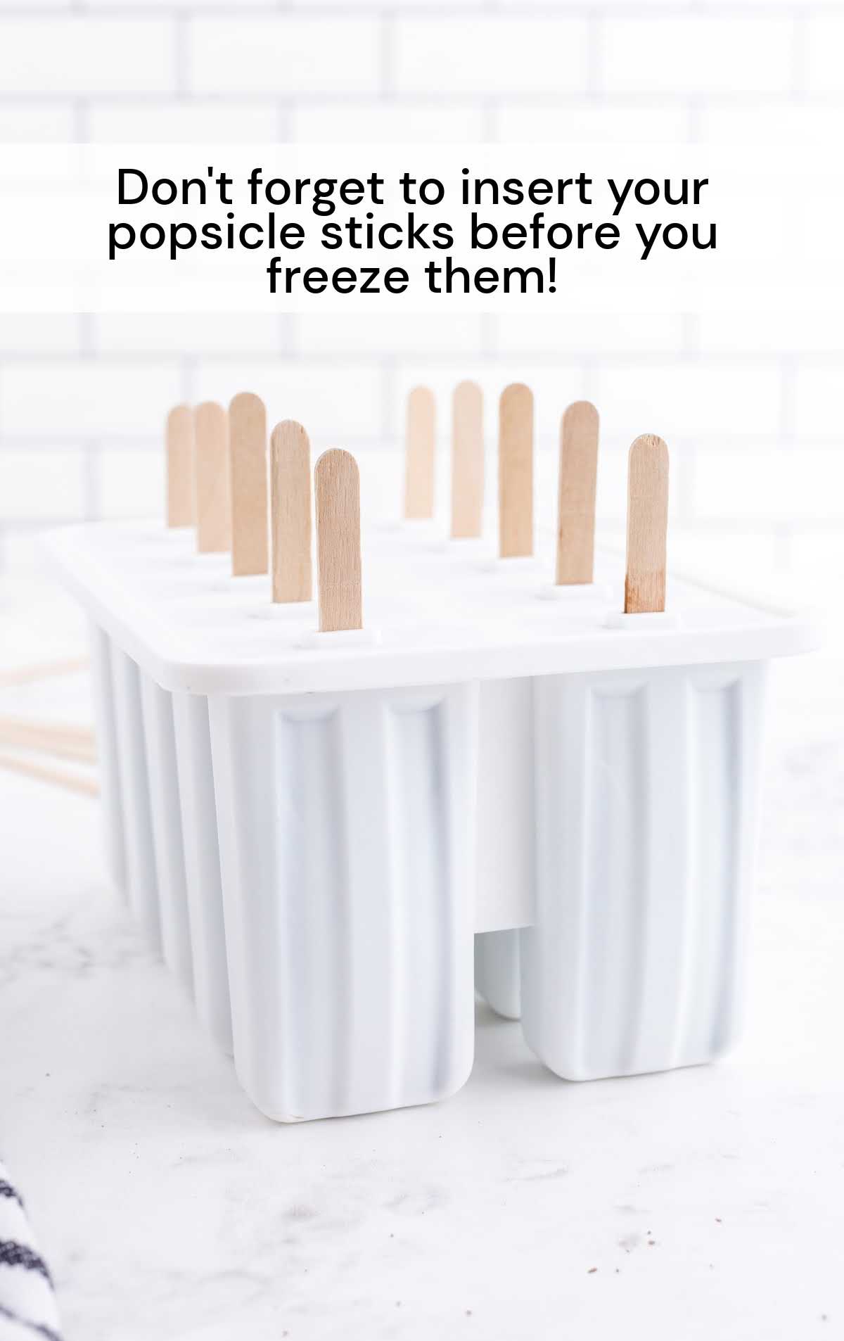 popsicle sticks inserted into the popsicle mold
